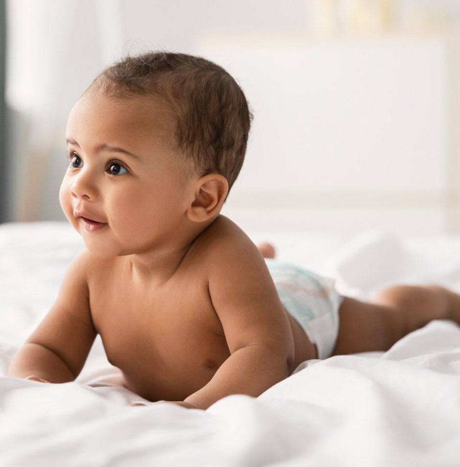 Baby smiling on a bed