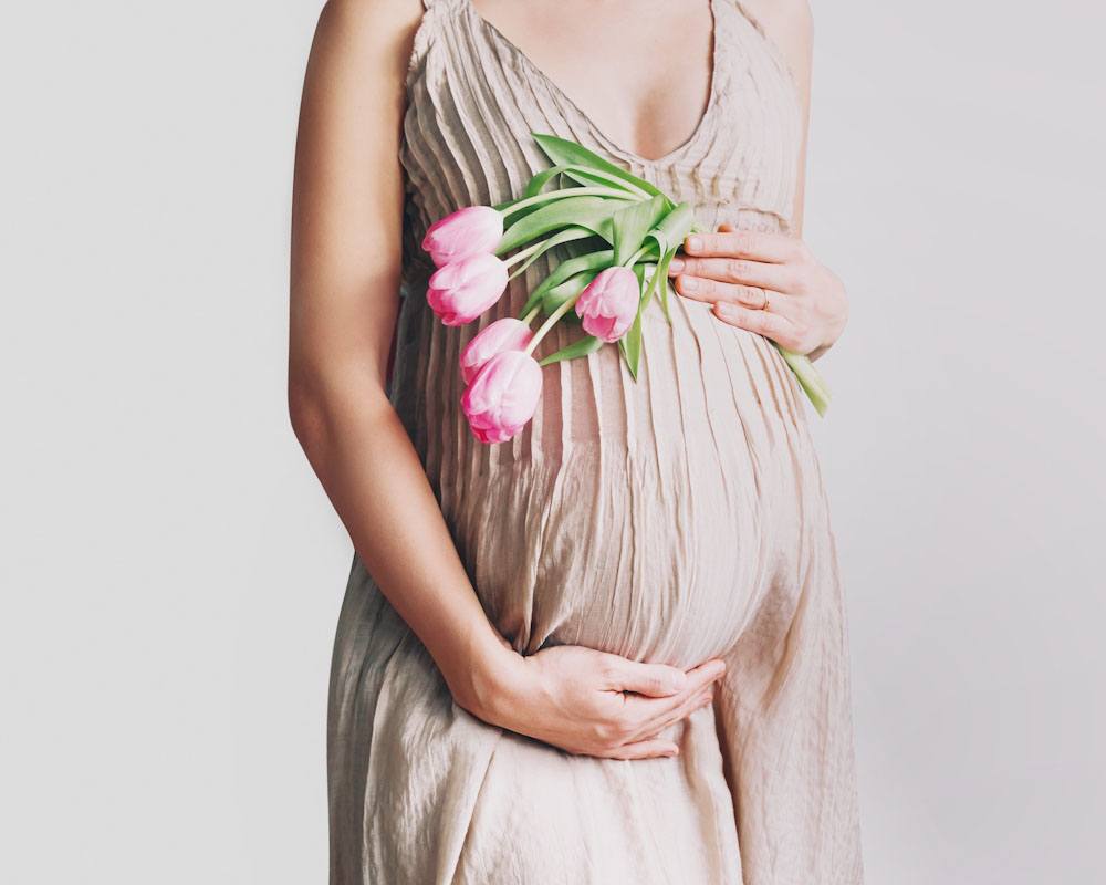 Expectant mother holding tulips