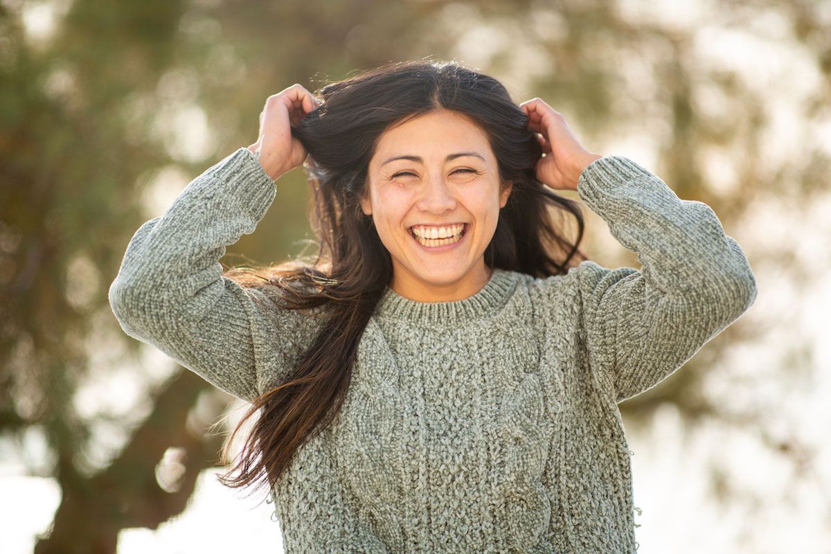 Happy woman touching her hair